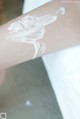 A close up of a person's arm with a lot of cream on it.