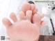 A close up of a person's feet on a bed.