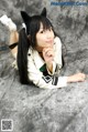 A woman with long black hair wearing a cat ears headband.