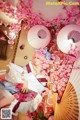 A woman in a kimono laying on a bed of flowers.