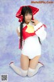 A woman in a white and red outfit posing for a picture.