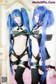 A couple of women with long blue hair standing next to each other.