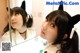 A woman wearing a cat ears headband in front of a mirror.