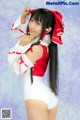 A woman in a white and red outfit posing for a picture.