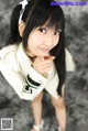 A woman in a white shirt and white shoes posing for a picture.