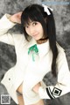 A woman in a white shirt and blue panties posing for a picture.