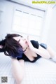 A woman laying on the floor with her eyes closed.