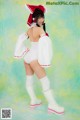 A woman in a white and red outfit posing for a picture.