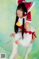 A woman in a maid outfit is posing for a picture.