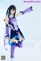 A woman in a purple and blue outfit is posing for a picture.