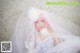 A woman in a wedding dress with a veil over her head.
