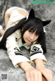A woman in a cat costume laying on the ground.