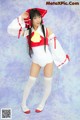 A woman in a white and red outfit posing for a picture.