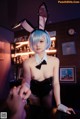 A woman in a bunny costume is posing for a picture.