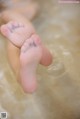 A close up of a person's feet in the water.