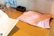 A pink paper bag sitting on top of a wooden table.