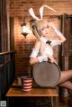 A woman in a bunny costume sitting on a table.