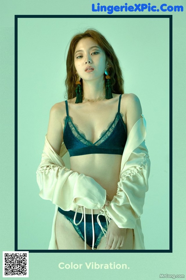 A woman wearing a blue bra and a white shirt.
