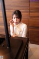 A woman sitting at a desk in front of a computer.