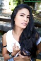 A woman with long black hair posing for a picture.